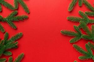Christmas holiday background with copy space for advertising text. Fir branches on color background . Flat lay, top view photo