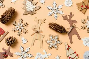 Top view of New Year toys and decorations on orange background. Christmas time concept photo