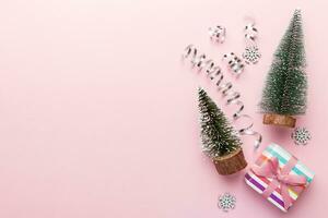 Flat lay composition with christmas trees on color background. Top view with copy space photo
