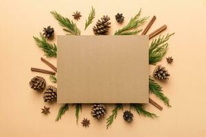 Flat lay Christmas composition. square Paper blank, pine tree branches, christmas decorations on Colored background. Top view, copy space for text photo