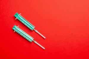 Top view of medical syringes on colorful background. Health care concept with copy space photo