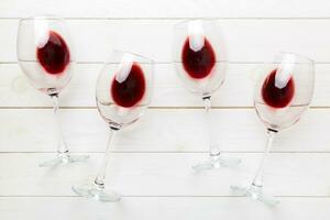 Many glasses of red wine at wine tasting. Concept of red wine on colored background. Top view, flat lay design photo
