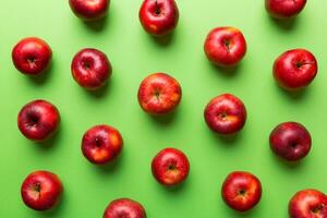 Many red apples on colored background, top view. Autumn pattern with fresh apple above view photo