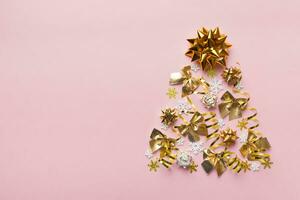 Christmas tree made from colored ball decoration on colored background, view from above. New Year minimal concept with copy space photo