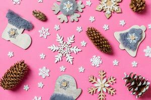 Top view of holiday toys and decorations on pink Christmas background. New Year time concept photo