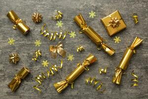 Christmas crackers with shiny confetti on color background, top view, copy space photo