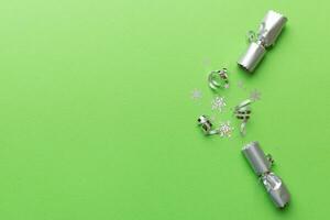 Christmas crackers with shiny confetti on color background, top view, copy space photo