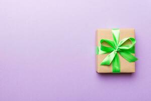 Holiday present box over colored background, top view. Copy space for design photo
