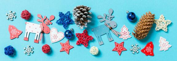 Banner top view of New Year toys and decorations on blue background. Christmas time concept with empty space for your design photo