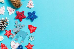 Top view of New Year toys and decorations on blue background. Christmas time concept with empty space for your design photo