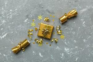 Christmas crackers with shiny confetti on color background, top view, copy space photo