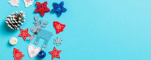 Top view Banner of New Year toys and decorations on blue background. Christmas time concept with empty space for your design photo