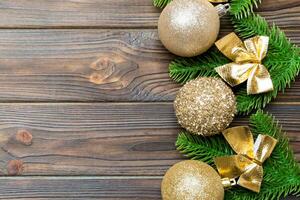 Set of festive balls, fir tree and Christmas decorations on wooden background. Top view of New Year ornament concept with copy space photo