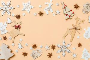 Festive decorations and toys on orange background. Merry Christmas concept with copy space photo