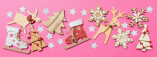 Top view Banner of pink background decorated with festive toys and Christmas symbols reindeers and New Year trees. Holiday concept with copy space photo