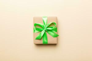 Holiday present box over colored background, top view. Copy space for design photo