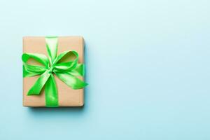 Holiday present box over colored background, top view. Copy space for design photo