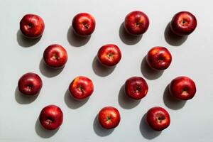 Many red apples on colored background, top view. Autumn pattern with fresh apple above view photo