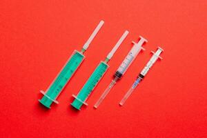 Top view of medical syringes on colorful background. Health care concept with copy space photo