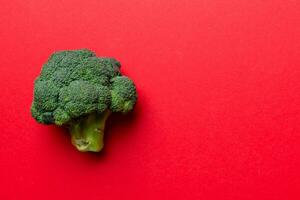 Top view fresh green broccoli vegetable on Colored background. Broccoli cabbage head Healthy or vegetarian food concept. Flat lay. Copy space photo