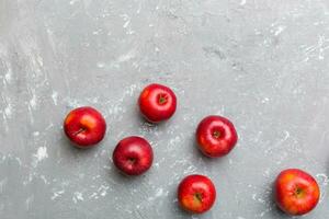 Many red apples on colored background, top view. Autumn pattern with fresh apple above view with copy space for design or text photo