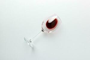 One glasses of red wine at wine tasting. Concept of red wine on colored background. Top view, flat lay design photo