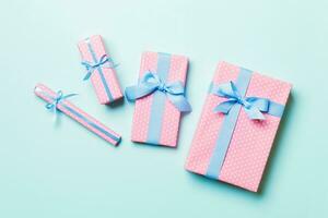 Top view Christmas present box with blue bow on blue background photo