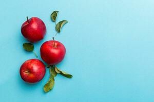 Many red apples on colored background, top view. Autumn pattern with fresh apple above view with copy space for design or text photo