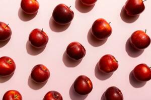 Many red apples on colored background, top view. Autumn pattern with fresh apple above view photo