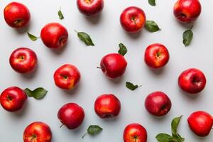 Many red apples on colored background, top view. Autumn pattern with fresh apple above view photo