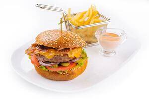 Beef burger with bacon and french fries photo