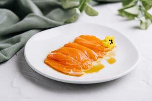 Chopped fresh salmon fillet on white plate photo