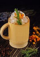 Fresh cocktail with sea buckthorn, juice, rosemary and ice photo