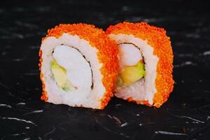 Sushi roll with shrimp, avocado cheese and tobiko caviar photo