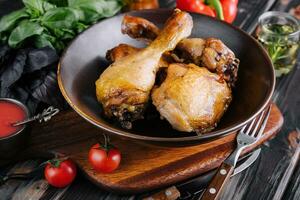 Fried chicken on the plate with tomatoes photo