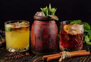 three different alcoholic cocktails with old-fashioned glasses photo