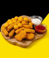 nuggets and cheese balls with sauces photo