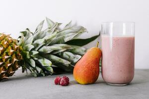 Smoothies of pear, pineapple and raspberries with yogurt photo