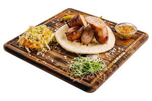 Delicious grilled sausages on a board with mustard sauce photo