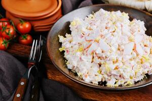 Salad with corn, crab sticks, cucumbers, eggs and mayonnaise photo