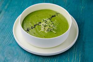 Plate of broccoli and green peas cream soup photo