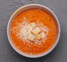 Pumpkin carrot cream soup with parmesan photo