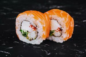 sushi rolls philadelphia with shrimp on black photo