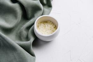 Grated aged italian parmesan cheese in white bowl photo
