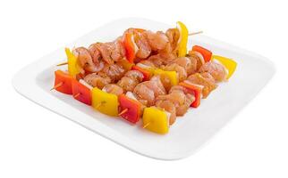 raw chicken skewers with onions and pepper photo