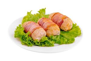 Pork cutlets wrapped in bacon on white photo