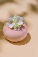 Pink mousse cake with mirror glaze decorated with flowers photo