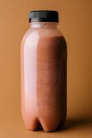 chocolate smoothies milkshake in bottle on chocolate background photo