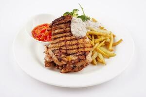 Grilled steak with asparagus on white plate photo
