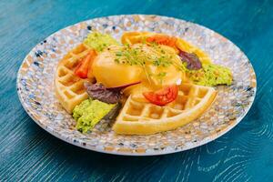 belgian waffles with poached egg and avocado photo